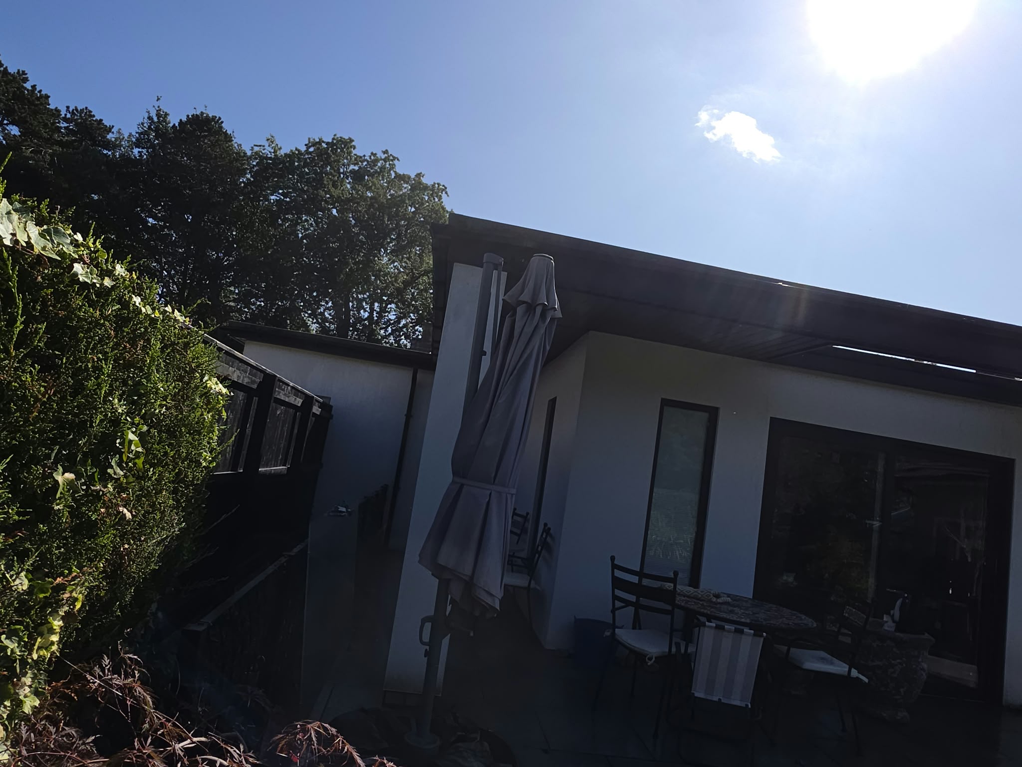 Patio doors beneath a dark fascia on the back of a house